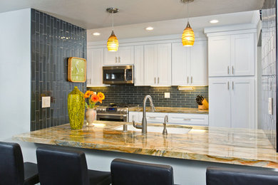 Inspiration for a mid-sized contemporary galley eat-in kitchen in San Diego with an undermount sink, shaker cabinets, white cabinets, granite benchtops, blue splashback, glass tile splashback, stainless steel appliances, dark hardwood floors and with island.