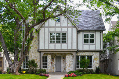 Elegant two-story mixed siding exterior home photo in Dallas