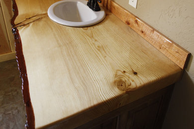 Inspiration for a mid-sized craftsman ceramic tile bathroom remodel in Other with raised-panel cabinets, gray cabinets, a drop-in sink and wood countertops