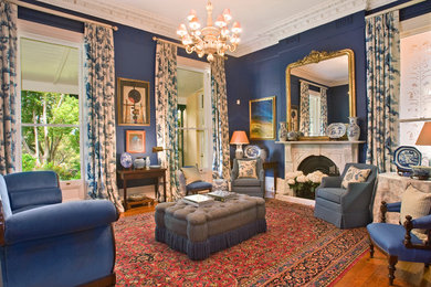 Traditional formal enclosed living room in Sydney with blue walls, medium hardwood floors and a standard fireplace.