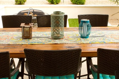Example of a mid-sized tuscan backyard concrete patio design in Phoenix with a roof extension