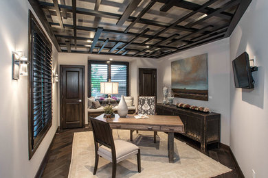Mid-sized transitional freestanding desk dark wood floor study room photo in Cincinnati with beige walls