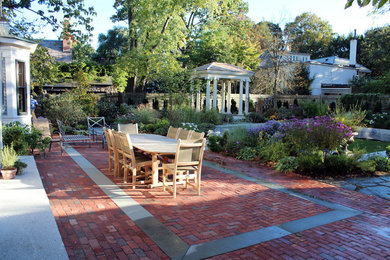 Patio fountain - mid-sized mediterranean backyard brick patio fountain idea in Boston with no cover