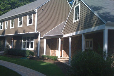 Mid-sized traditional beige two-story mixed siding exterior home idea in New York