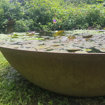 Blooming water lilly in 7' cast iron sugar kettle water feature