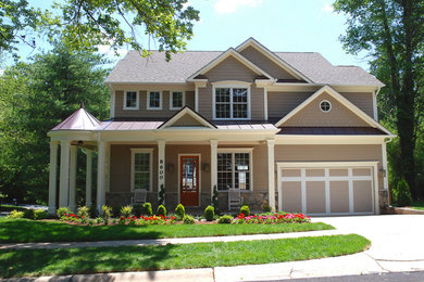 Inspiration for a large beige two-story vinyl exterior home remodel in Baltimore