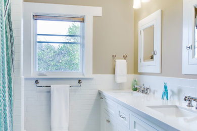 Design ideas for a mid-sized arts and crafts kids bathroom in Santa Barbara with shaker cabinets, white cabinets, engineered quartz benchtops, an alcove tub, a shower/bathtub combo, a two-piece toilet, white tile, ceramic tile, beige walls, porcelain floors and an undermount sink.