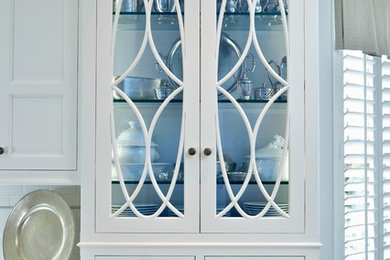 Kitchen pantry - large transitional medium tone wood floor kitchen pantry idea in New York with a farmhouse sink, recessed-panel cabinets, yellow cabinets, marble countertops, white backsplash, subway tile backsplash, white appliances and an island