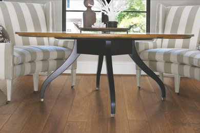 Small elegant medium tone wood floor and brown floor dining room photo in Other with beige walls and no fireplace