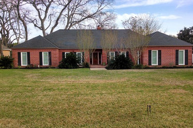 Example of a classic one-story brick exterior home design in Houston