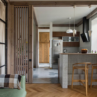 Trendy u-shaped gray floor open concept kitchen photo in Saint Petersburg with flat-panel cabinets, brown cabinets, gray backsplash and no island