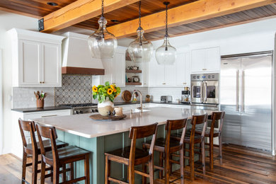Large mountain style l-shaped exposed beam eat-in kitchen photo in New York with shaker cabinets, white cabinets, quartz countertops, white backsplash, subway tile backsplash, stainless steel appliances and an island