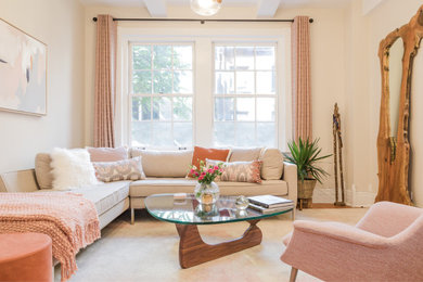 Trendy medium tone wood floor, brown floor and exposed beam living room photo in New York with beige walls