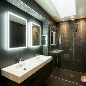 Sleek Black Designer wet-room Shower with Mosaics in a feature Basin Wall