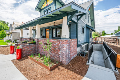 Example of a mid-sized arts and crafts blue three-story wood and clapboard exterior home design in Seattle with a mixed material roof and a gray roof