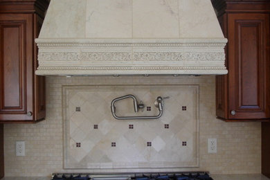 Example of a classic kitchen design in New York with dark wood cabinets and beige backsplash