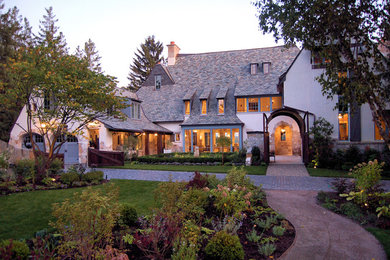 Inspiration for a huge craftsman gray two-story stucco exterior home remodel in Milwaukee with a shingle roof