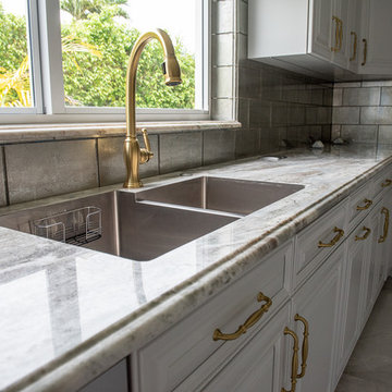 Transitional Kitchen Done in a 2 Tone Color With Integrated Dining Table