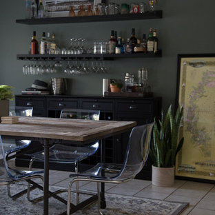 This is an example of a large eclectic single-wall home bar in New Orleans with black cabinets.