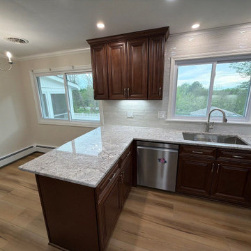 USCD cabinetry accompanied granite countertops, porcelain tile backsplash and Ca
