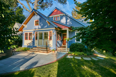 Mid-sized arts and crafts blue two-story wood and shingle exterior home photo in New York with a shingle roof and a gray roof