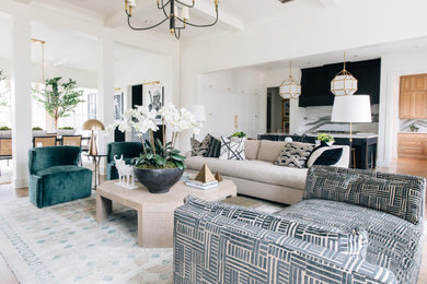 Example of a large transitional enclosed medium tone wood floor, brown floor and coffered ceiling living room design in Other with white walls, a standard fireplace and no tv