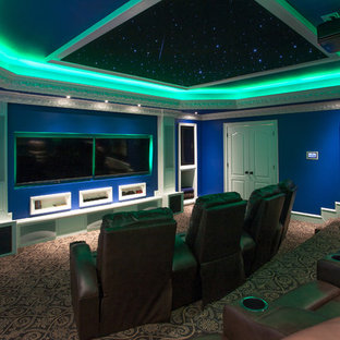 Photo of a small modern enclosed home cinema in Little Rock with blue walls, carpet and a projector screen.