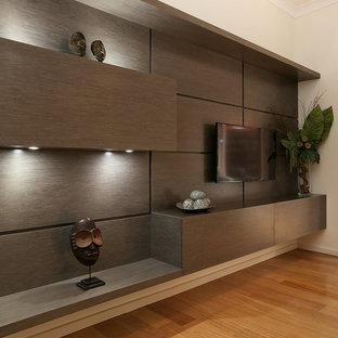 Home theater - large contemporary open concept medium tone wood floor home theater idea in Adelaide with brown walls and a wall-mounted tv