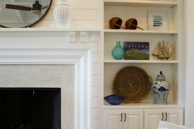 Example of a mid-sized beach style brown floor living room design in Wichita with white walls, a standard fireplace and a tile fireplace