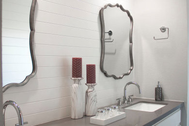 Mid-sized transitional master multicolored tile and porcelain tile porcelain tile, gray floor, double-sink and shiplap wall bathroom photo in Houston with raised-panel cabinets, white cabinets, a two-piece toilet, an undermount sink, quartzite countertops, gray countertops, a built-in vanity and white walls
