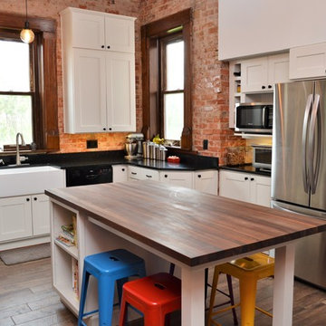 Bourbon, IN. Haas Signature Collection. Farmhouse Kitchen with Exposed Brick
