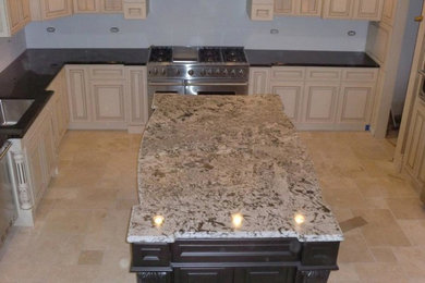 Kitchen - transitional kitchen idea in Chicago with an undermount sink, distressed cabinets, stainless steel appliances and an island