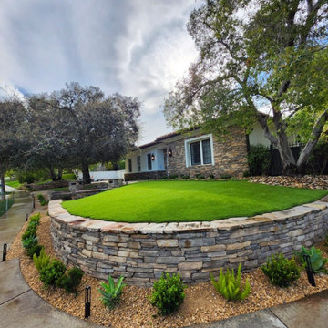 Calabasas Luxury Front Yard Remodel with Custom Stone Retaining Wall & Evergreen