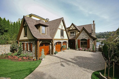 Traditional two-storey brown exterior in Dallas with stone veneer.
