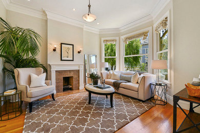Example of a trendy formal and enclosed light wood floor living room design in San Francisco with beige walls, a standard fireplace and a stone fireplace