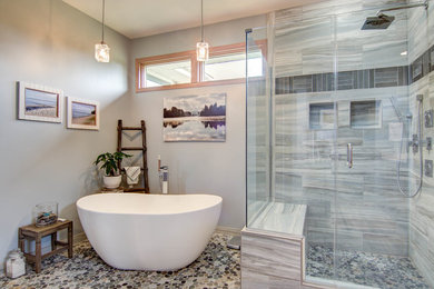 Large transitional master multicolored tile and porcelain tile pebble tile floor and multicolored floor bathroom photo in Chicago with a one-piece toilet, gray walls, an undermount sink, solid surface countertops and a hinged shower door
