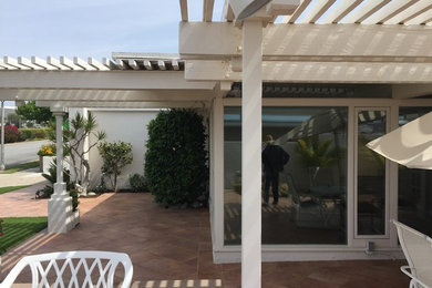 Inspiration for a mid-sized traditional backyard patio in Orange County with decking and a pergola.