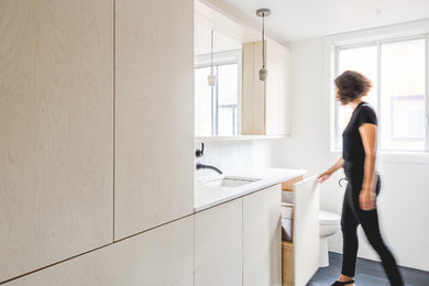 Inspiration for a mid-sized contemporary master blue tile ceramic tile and blue floor freestanding bathtub remodel in Montreal with flat-panel cabinets, light wood cabinets, a one-piece toilet, white walls, an undermount sink, quartz countertops and a hinged shower door
