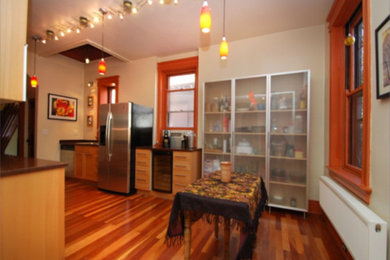 Example of a mid-sized classic galley medium tone wood floor kitchen pantry design in Cincinnati with a drop-in sink, recessed-panel cabinets, light wood cabinets, granite countertops, stainless steel appliances and no island