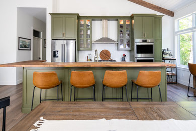 Eat-in kitchen - mid-sized transitional l-shaped medium tone wood floor, brown floor and shiplap ceiling eat-in kitchen idea in Other with an undermount sink, shaker cabinets, green cabinets, quartz countertops, white backsplash, cement tile backsplash, stainless steel appliances, an island and white countertops