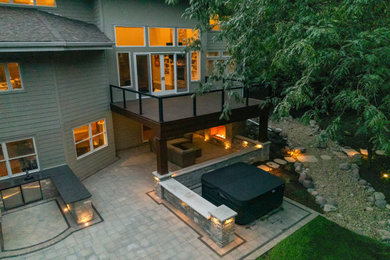 Patio - mid-sized traditional backyard concrete paver patio idea in Chicago with a bbq area and a roof extension