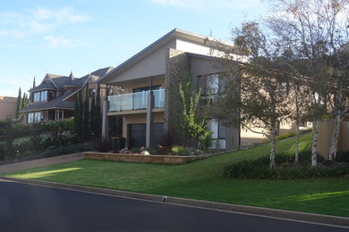 This is an example of a large modern exterior in Wollongong with metal siding.