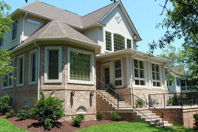Inspiration for a large traditional partial sun backyard brick landscaping in Charleston.