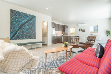 Example of a mid-sized 1960s open concept and formal gray floor and concrete floor living room design in Salt Lake City with no tv, beige walls and no fireplace