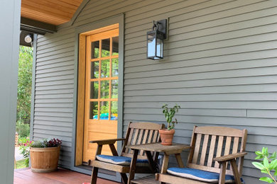 Mid-sized elegant front porch photo in Burlington with a roof extension