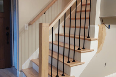 Small arts and crafts wooden l-shaped mixed material railing staircase photo in Other with painted risers