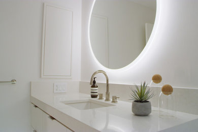 Bathroom - mid-sized modern 3/4 white tile and subway tile porcelain tile, gray floor and single-sink bathroom idea in Tampa with flat-panel cabinets, white cabinets, a one-piece toilet, white walls, an undermount sink, quartz countertops, white countertops, a niche and a floating vanity
