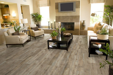 Mid-sized transitional formal and open concept light wood floor and gray floor living room photo in Toronto with beige walls, a standard fireplace, a tile fireplace and a wall-mounted tv