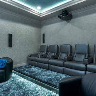 Design ideas for a medium sized bohemian enclosed home cinema in Tampa with carpet, a projector screen and blue floors.