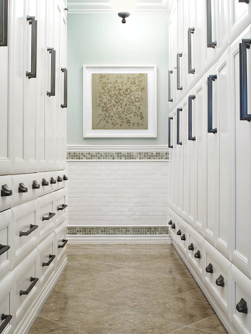 Closet Floor Limestone Inspiration for a large timeless dressing room remodel in Charleston with limestone floors, recessed-